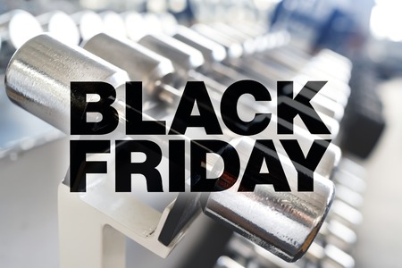Black friday poster. Rows of dumbbells in the gym with high contrast lightの写真素材