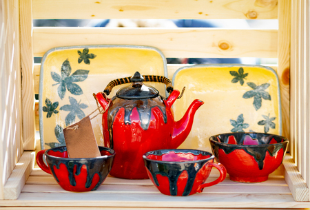 Handcrafted clay tea set in wooden box.の写真素材