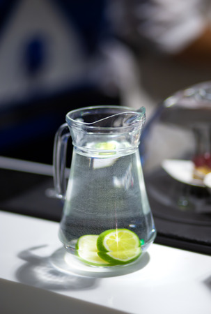 Decanter with lime water on bar counterの写真素材