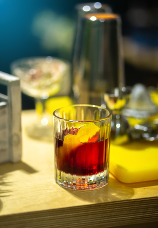 Glass of whiskey with lemon on bar counterの写真素材