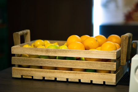 Wooden box with citruses on the bar counterの写真素材