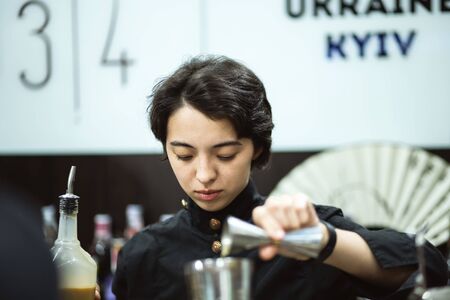Kyiv, Ukraine, September 28, 2018. Woman bartender preparing cocktail on Barometer international bar...