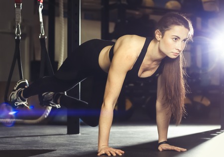 Young women doing exercise with suspension systemの写真素材