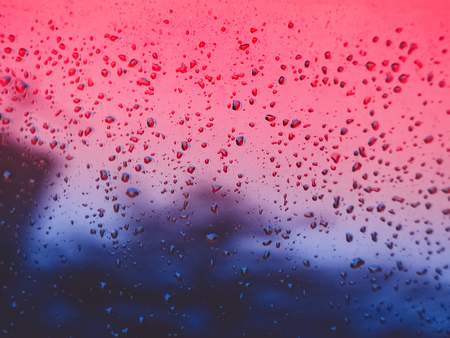 Raindrops on gradient toned glass. Blurry reflectionsの写真素材