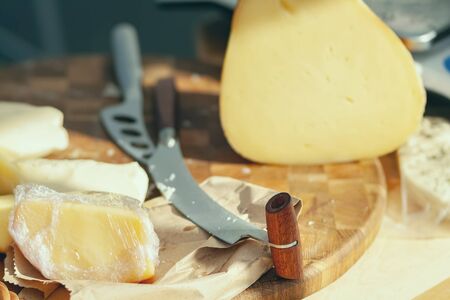 Knife for slicing cheese. Production of natural cheese.の写真素材