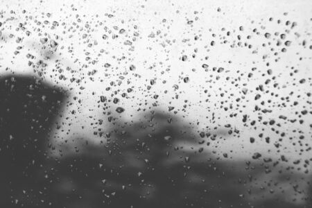 Raindrops on gradient toned glass. Blurry reflectionsの写真素材