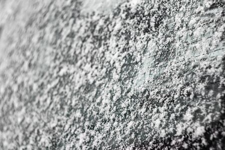 Snowflakes on a car glass close-up. Winter backgroundの写真素材