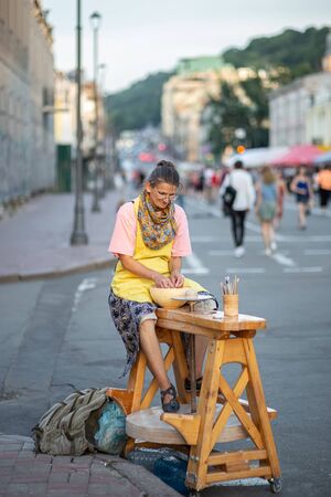 Kyiv, Ukraine, June 13, 2019. Woman doing pottery on Sagaydachnogo streetのeditorial素材