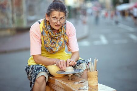 Kyiv, Ukraine, June 13, 2019. Woman doing pottery on Sagaydachnogo streetのeditorial素材