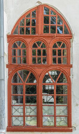 Window of an old house in an exquisite wooden frame
