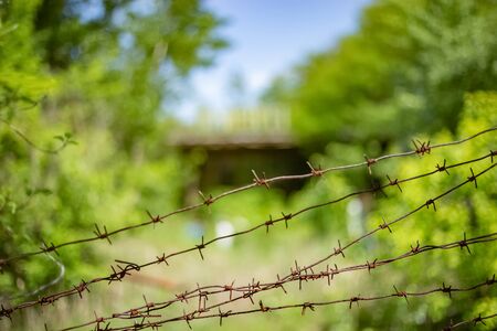 Rusty barbed wire on the background of an abandoned cafe in the city of Pripyatのeditorial素材