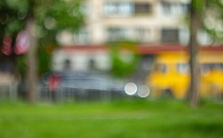 Blurred background photo.Cityscape bokeh. Defocused abstract city.Background out of focus.Can use as wallpaper, design. Summer blurry city backdrop.の写真素材