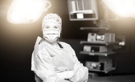 Surgeon woman in surgeon suit posing in the operating roomの写真素材