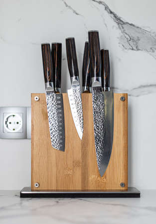 Kitchen Damascus Knife set on wooden magnetic holderの写真素材