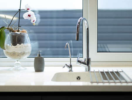 Expensive luxury kitchen sink with chrome faucetの写真素材