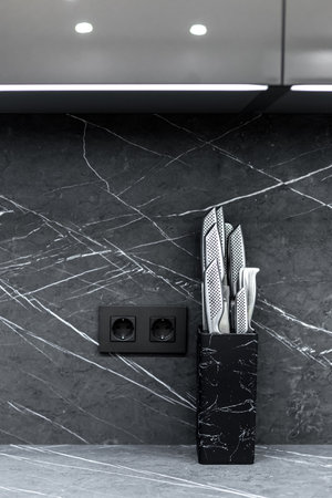 Steel kitchen knife set on black stone knife holderの写真素材