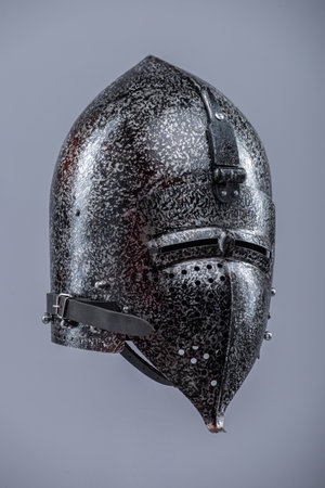 Medieval Knight Helmet with Visor. Polished metal head protection with ventilation holes and a hinged face guard.の写真素材