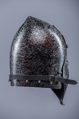 Medieval Knight Helmet with Visor. Polished metal head protection with ventilation holes and a hinged face guard.の写真素材