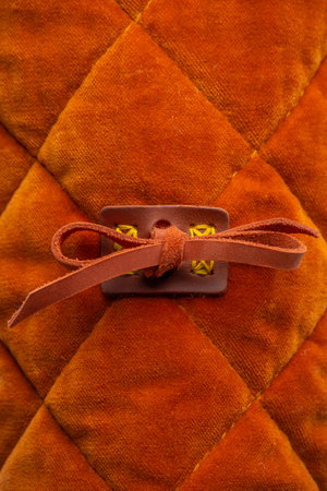 Close-up of Gambeson Sleeve Tie. Detailed view of the fabric and leather tie used to fasten the sleeve of a medieval gambeson.の写真素材