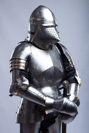 Full Suit of Fourteenth Century Knight's Plate Armor. Impressive display of medieval protective gear, including helmet, breastplate, gauntlets, and greavesの写真素材