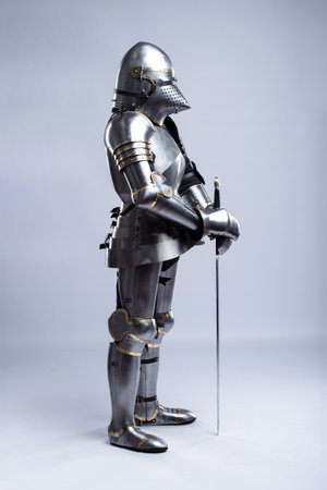 Full Suit of Fourteenth Century Knight's Plate Armor. Impressive display of medieval protective gear, including helmet, breastplate, gauntlets, and greavesの写真素材