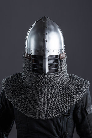 Simple Medieval Knight's Nasal Helmet with Chainmail. Classic head protection featuring a central nose guard and attached chainmail collar.の写真素材