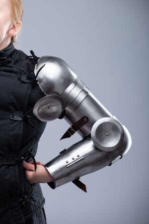 Polished Steel Medieval Arm Armor with Elbow Protection. Shiny and detailed gauntlets designed to protect the forearm and elbow in historical combat.の写真素材