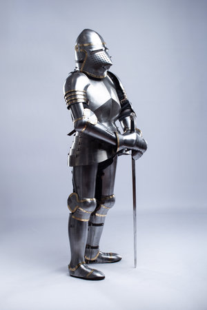 Full Suit of Fourteenth Century Knight's Plate Armor. Impressive display of medieval protective gear, including helmet, breastplate, gauntlets, and greavesの写真素材