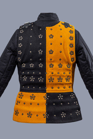 Two-Tone Medieval Brigandine Armor with Buckles. Unique torso protection featuring contrasting yellow and black panels with decorative rivets and leather strap closures.の写真素材