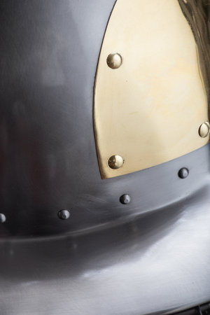 Refined Medieval Helmet with Golden Plate Detail. Elegant head protection featuring polished steel and a decorative golden plate element.の写真素材