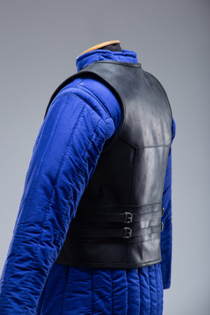 Black Leather Body Armor with Adjustable Straps. This image features a black leather torso armor with a segmented design on the chest and adjustable straps with buckles on the sides.の写真素材