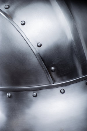 Silver Helmet with Wide Brim and Rivets. This image shows a shiny silver helmet featuring a wide, downward-sloping brim and several small rivets along its edges and the crown.の写真素材