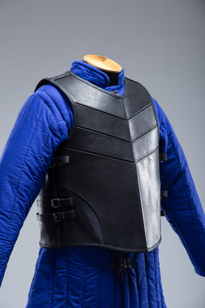 Black Leather Body Armor with Adjustable Straps. This image features a black leather torso armor with a segmented design on the chest and adjustable straps with buckles on the sides.の写真素材