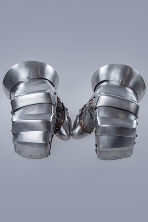 Pair of Silver Steel Gauntlets with Leather Interior. This image shows a pair of shiny silver steel gauntlets with a more basic and robust design compared to previous examples. The interior appears to be lined with brown leather.の写真素材