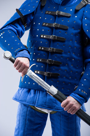 Blue Brigandine Armor with Sword. Medieval torso protection featuring metal plates and leather straps.の写真素材