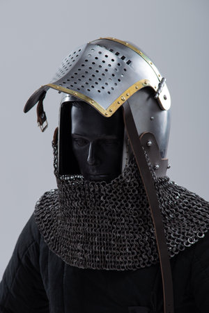 Steel Bascinet with Open Visor. Medieval helmet featuring brass accents and chainmail protection.の写真素材