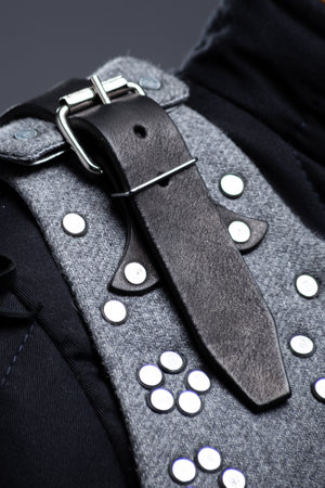 Close-up of Brigandine Armor Leather Straps and Rivets. Detailed view of the gray brigandine showing the leather straps, buckles, and metal rivet construction.の写真素材