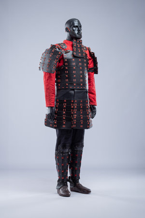 Full Black and Red Leather Armor Set on Mannequin. Warrior costume with cuirass, padded jacket, pants, and leg protection.の写真素材
