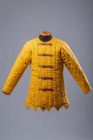 Yellow Padded Gambeson Jacket. Medieval quilted under-armor with leather strap closures.の写真素材