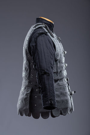 Gray Medieval Brigandine Armor with Leather Straps. This gray brigandine features overlapping metal plates riveted to a fabric base, secured with leather straps.の写真素材