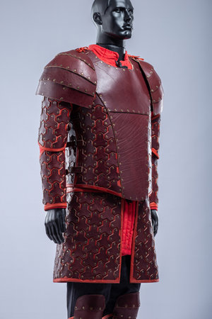 Profile View of Brown Leather Fantasy Armor Set. Mannequin in full costume with intricate details and red accents.の写真素材