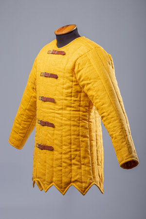 Yellow Padded Gambeson Jacket. Medieval quilted under-armor with leather strap closures.の写真素材