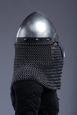 Norman Helmet with Chainmail Aventail. Medieval head protection with nasal bar and attached chainmail neck guard.の写真素材