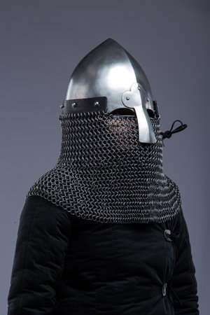 Norman Helmet with Chainmail Aventail. Medieval head protection with nasal bar and attached chainmail neck guard.の写真素材