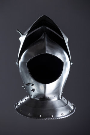 Silver Medieval Helmet with Lifted Visor. A polished silver helmet with a visor slightly raised, revealing a glimpse inside.の写真素材