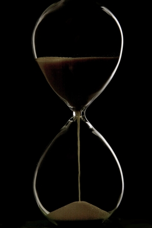 Sand trickling through hour glass