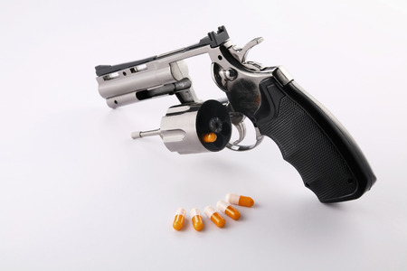 Handgun with a capsule in its cylinder