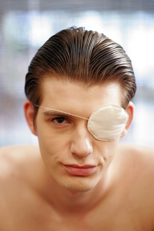 An injured guy with an eye patch on his left eye