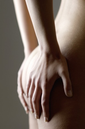 Woman touching her buttocks