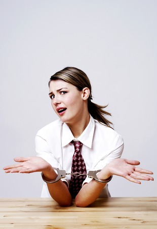 Businesswoman being handcuffed